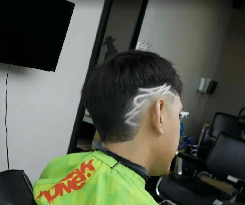 Skin fade with a freehand design, cut at Saloon Cuts in Broomfield
