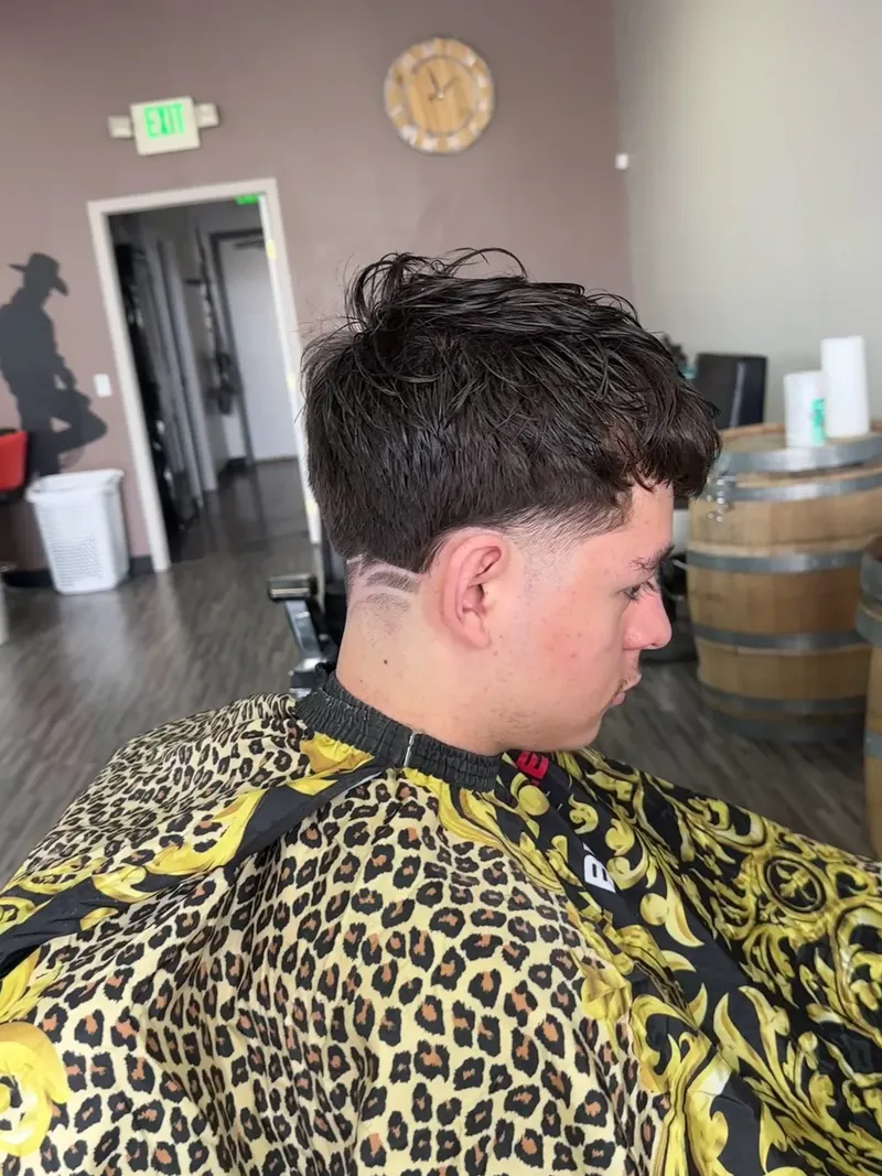 Fade with a line design on the side, cut at Saloon Cuts
