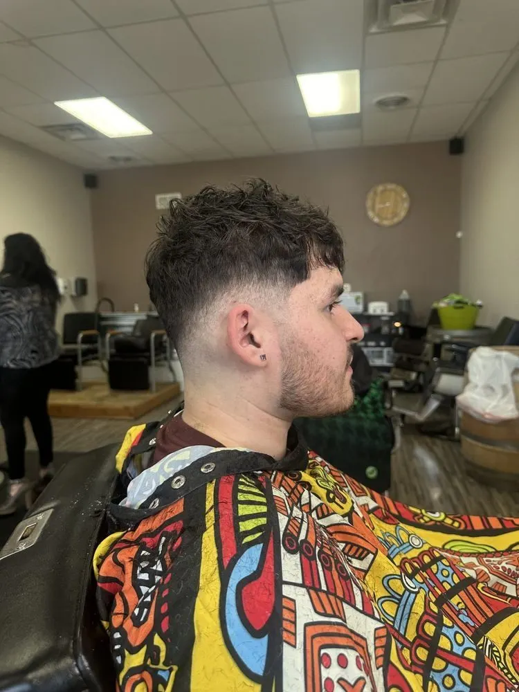 Curly textured top with a skin fade, cut at Saloon Cuts